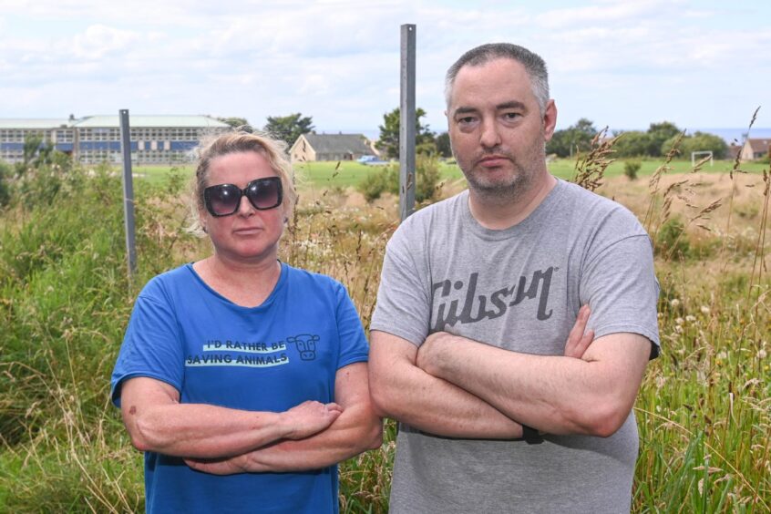 Fran Manning and Steve Barker stand next to the battery storage site in Macduff.