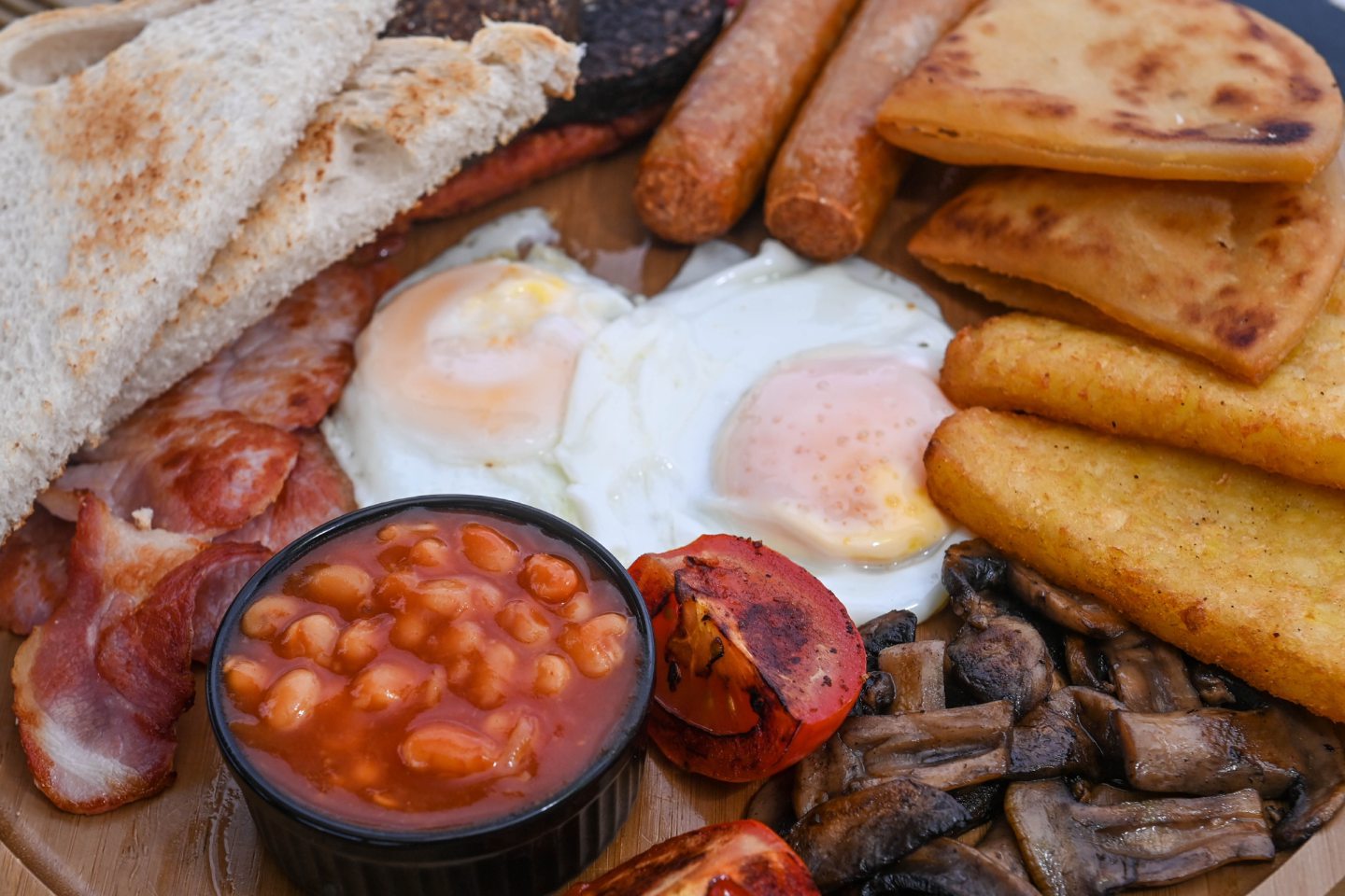 Close up of the Highlander breakfast, featuring beans, hash browns, bacon and more.