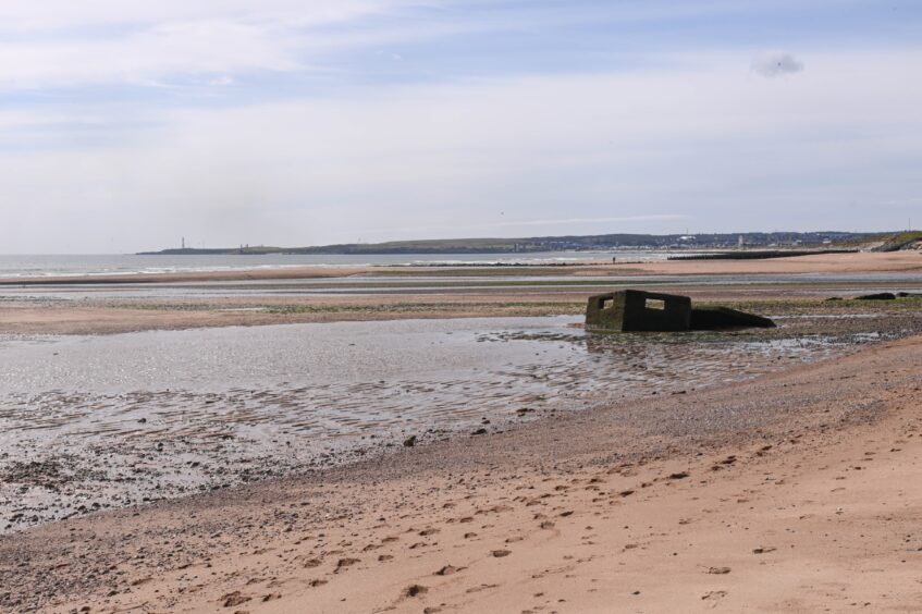 A pillbox on Donmouth Beach disappearing into the sand. 