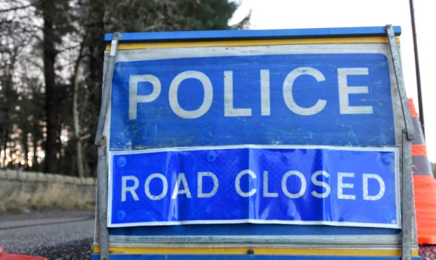 Blue police road closed sign.