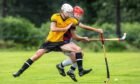 Fort William's Lewis Clark with Calum Grant (Kingussie).  Fort William v Kingussie in the Tulloch Homes Camanachd Cup semi final, played at Spean Bridge.