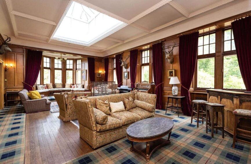 Sitting room inside the Highland castle for sale, featuring large skylight.