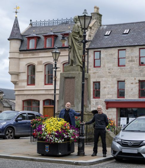 Huntly Community Council member Ian Little with fellow member Joe Lock next to a historic street light on The Square.