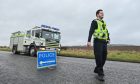 Police and firefighters at scene of crash on A98 near Buckie.