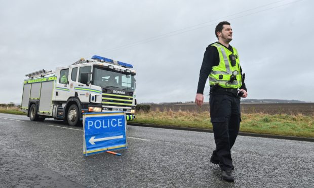 Police and firefighters at scene of crash on A98 near Buckie.