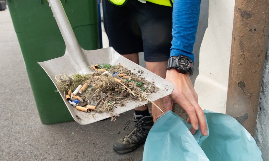 Mess on spade being dropped into bin bag. 