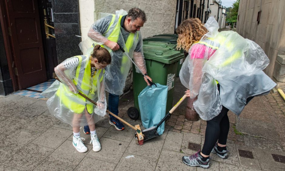 Volunteers picking up rubbish on Elgin High Street. 