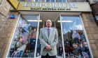 Ghulam Rasul standing outside Emporium Menswear.