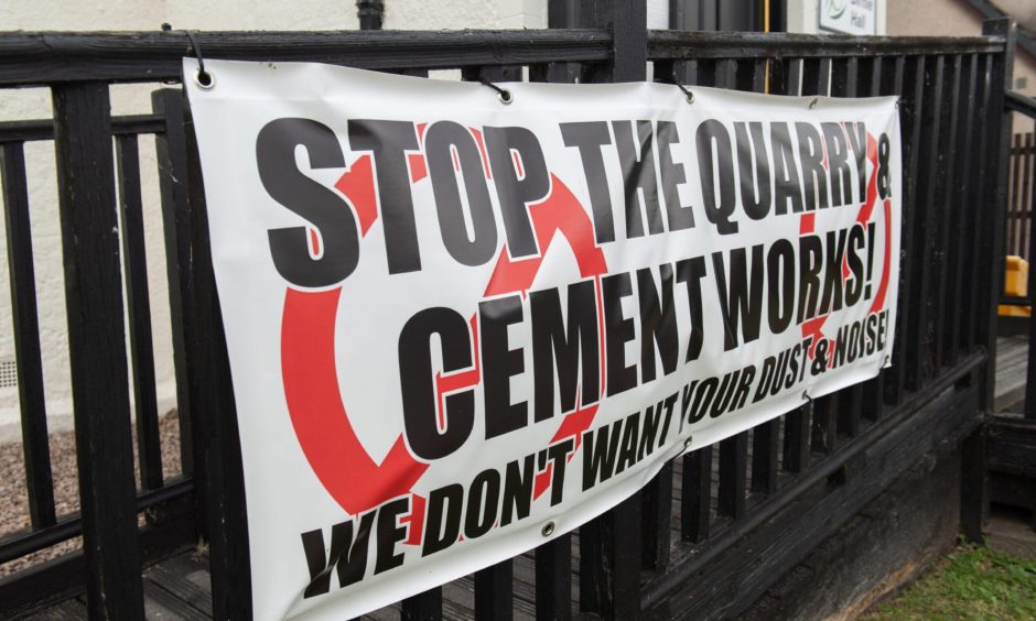 Banner opposing quarry tied to railings. 