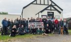 Campaigners outside Birnie Hall with "stop the quarry" banner.