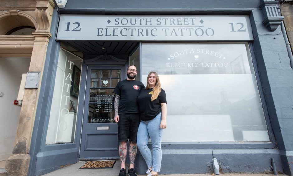 Mike Farquhar and Abbie Cummings standing outside South Street Electric Tattoo 