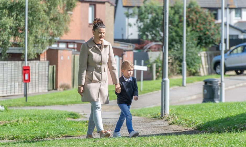 Kristina Nikolova walking while holding hand of Kristian. 