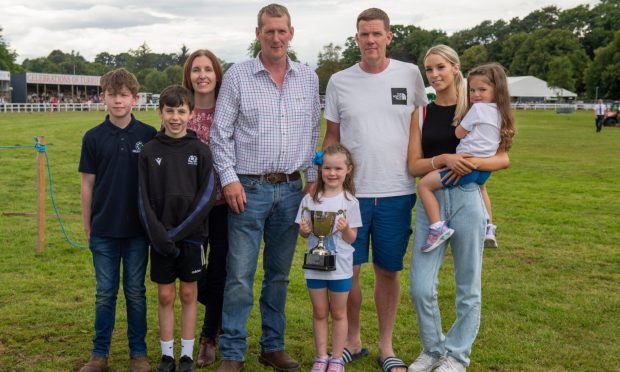 Joe Watson's brothers Murdo and Fraser and family with the Trophy. Image: Kenny Elrick/DC Thomson