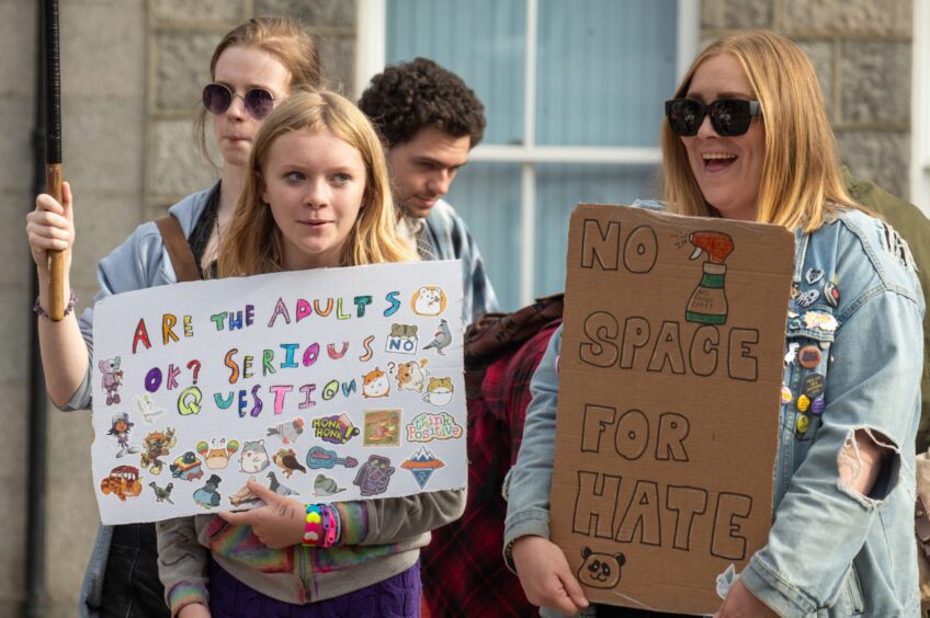 Anti-racism campaigners hold no hate signs during peaceful protest in Castlegate, Aberdeen.