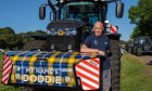 An impressive lineup of tractors traveled from the Haughs in Turriff, through Rothienorman, and arrived at Thainstone Mart in Inverurie. All images by Kenny Elrick/DC Thomson.