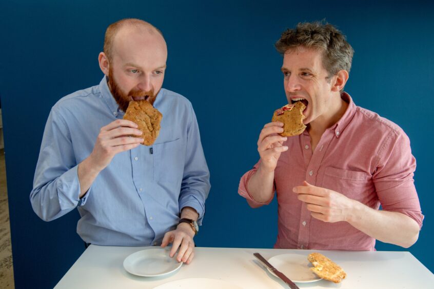 Graham and Andy taking a bite of their rowies