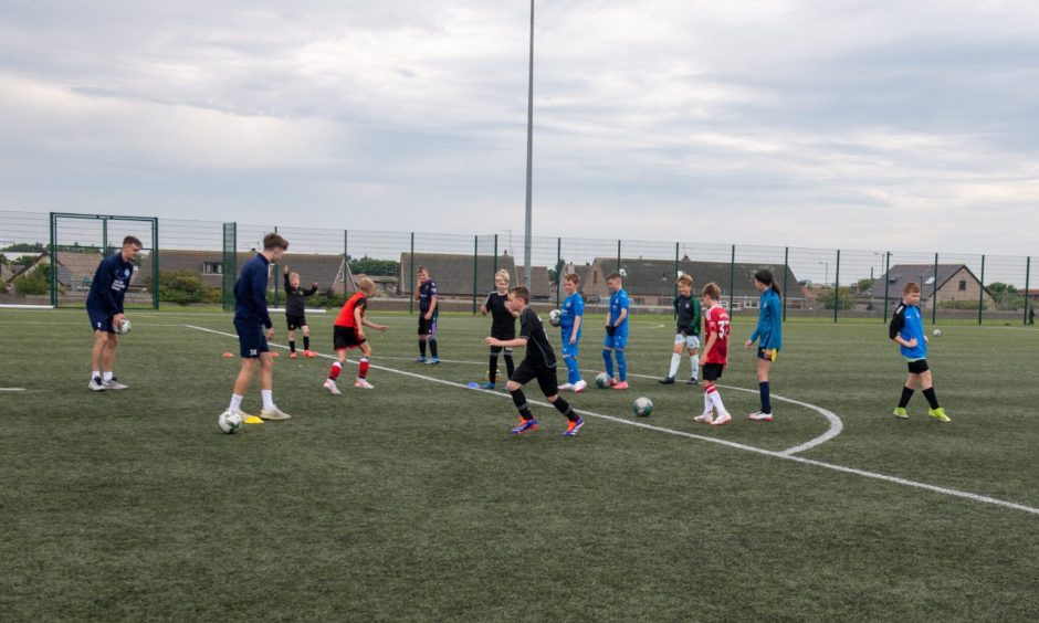 Players Danny Strachan and Arran Smith leading one of the summer coaching camps. Image: Kath Flannery/DC Thomson