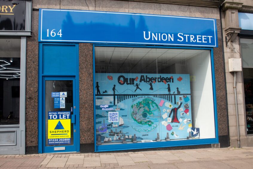 The vacant unit at 164 Union Street that has had its shopfront customised by The Graffiti Grannies.