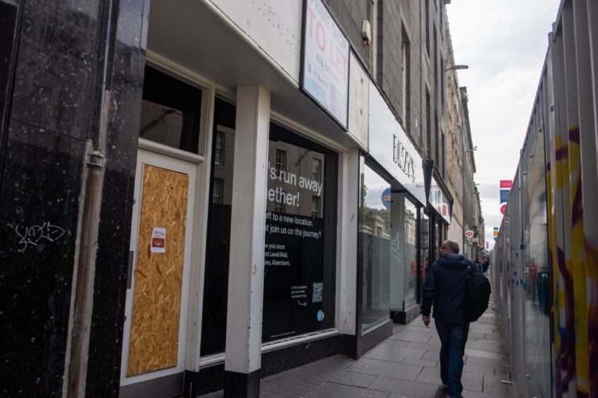 a man walks past the empty Lush store