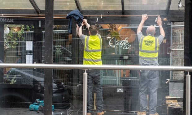 Workers carrying out the careful demolition of the Cafe 52 pavilion.