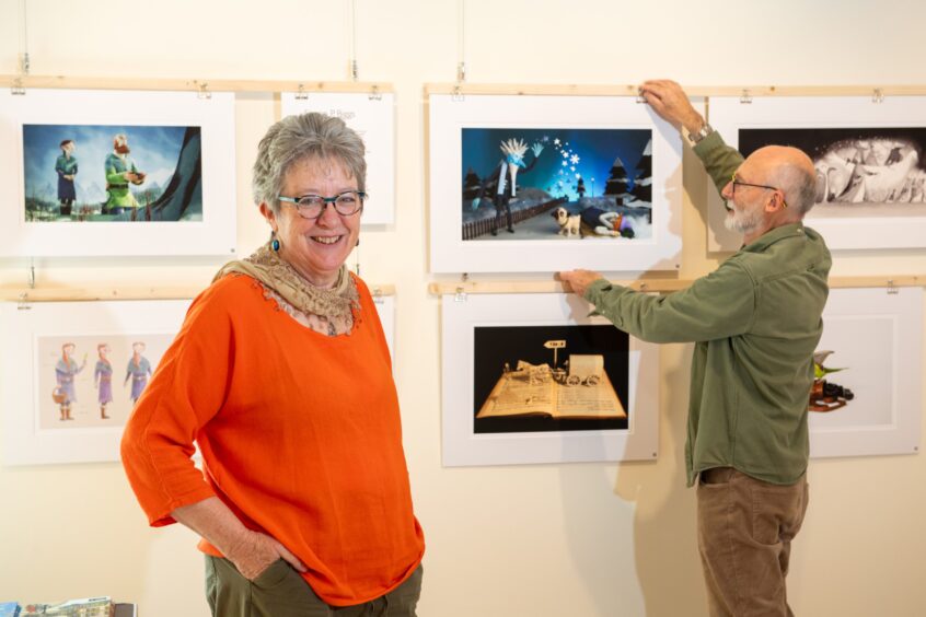 Helen and her husband Keith hanging some of the art work for the exhibition.