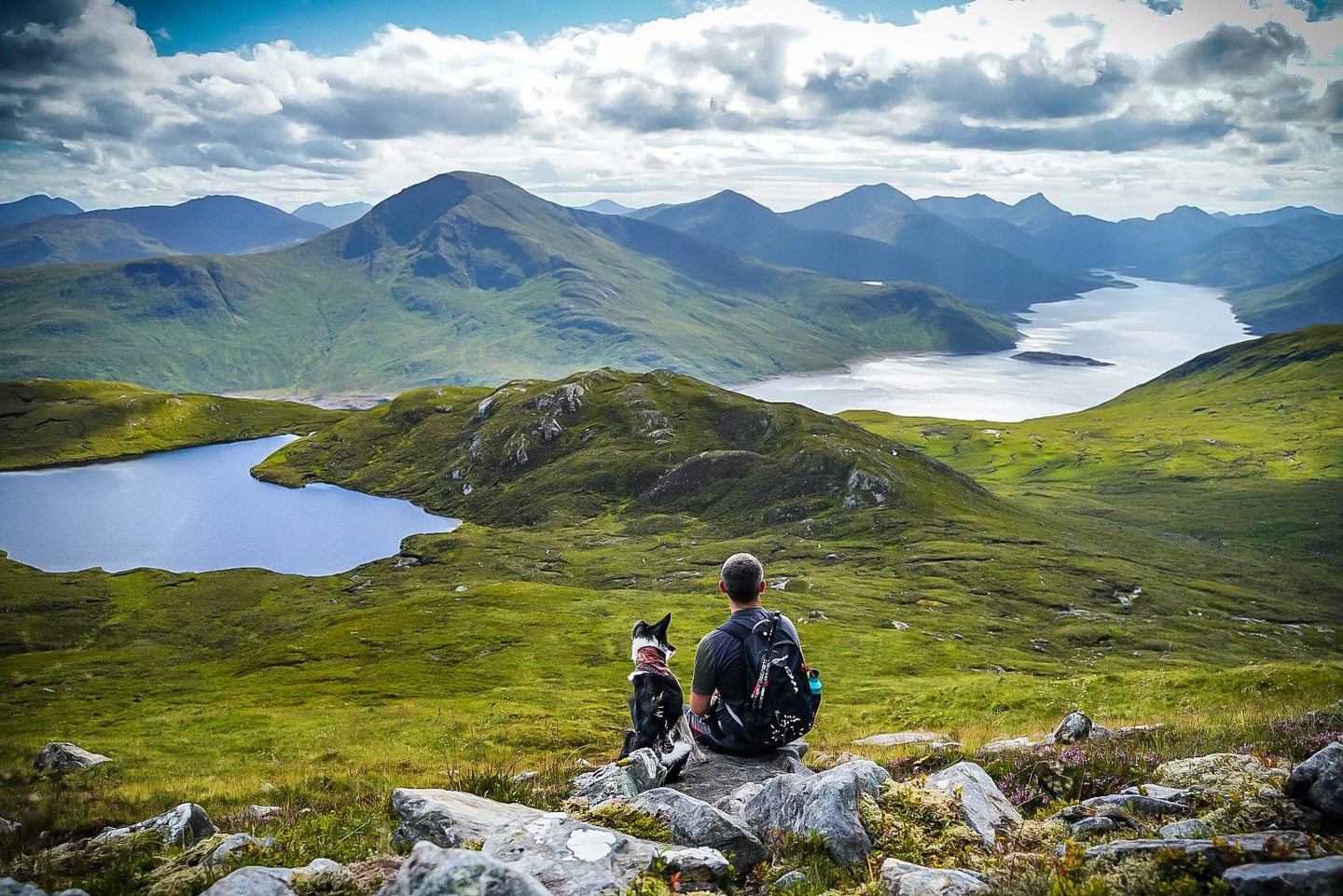 Luna the scottish collie and her owner Jonathon facing away from the camera while hillwalking in the highlands