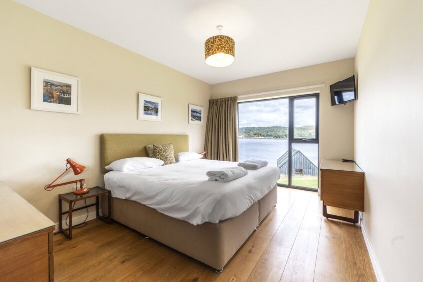 Another bedroom at The Old Barn, featuring views over Loch Ewe.