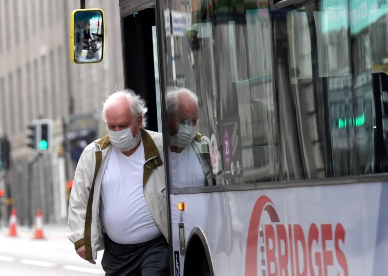 A passenger steps off the bus wearing a mask on Union Street in June 2020. Image: Kath Flannery/DC Thomson