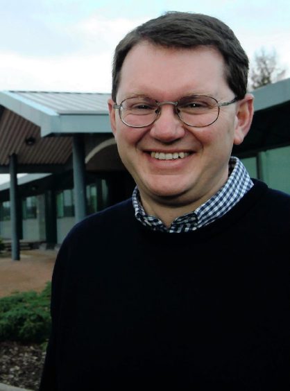 Archive photo of Peter Wilson smiling at camera. 