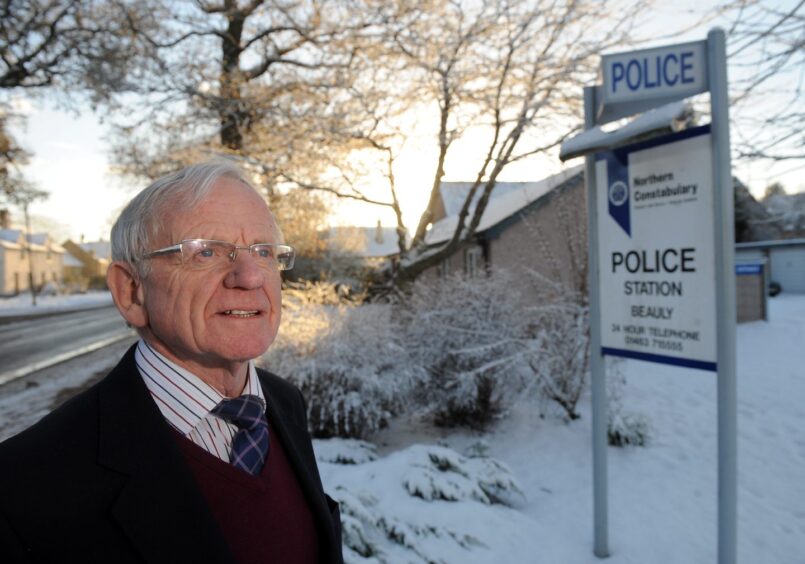 James pictured in a snowy village scene beside the sign for the police station in 2010 when he was chairman of Beauly Community Council, campaigning to retain the police station. 