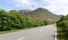 Empty A82 at Glencoe with trees and hills surrounding.