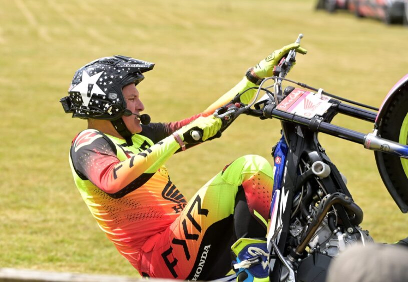 Motorcycle stunt rider Steve Colley puts on his afternoon performance for the large crowd. 