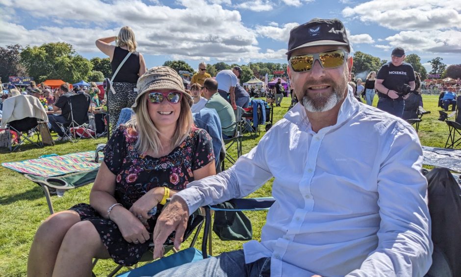 Festival-goers enjoy the sun at Cooper Park.