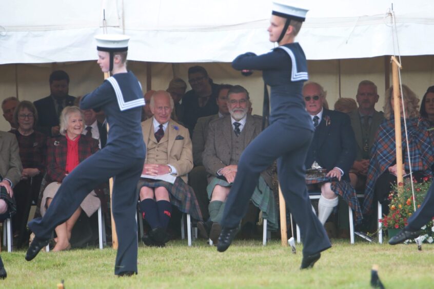 Dancers in blue and white sailors outfits perform for King Charles