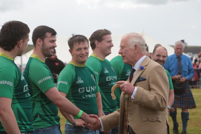 King Charles meeting athletes at the Mey Highland Games.