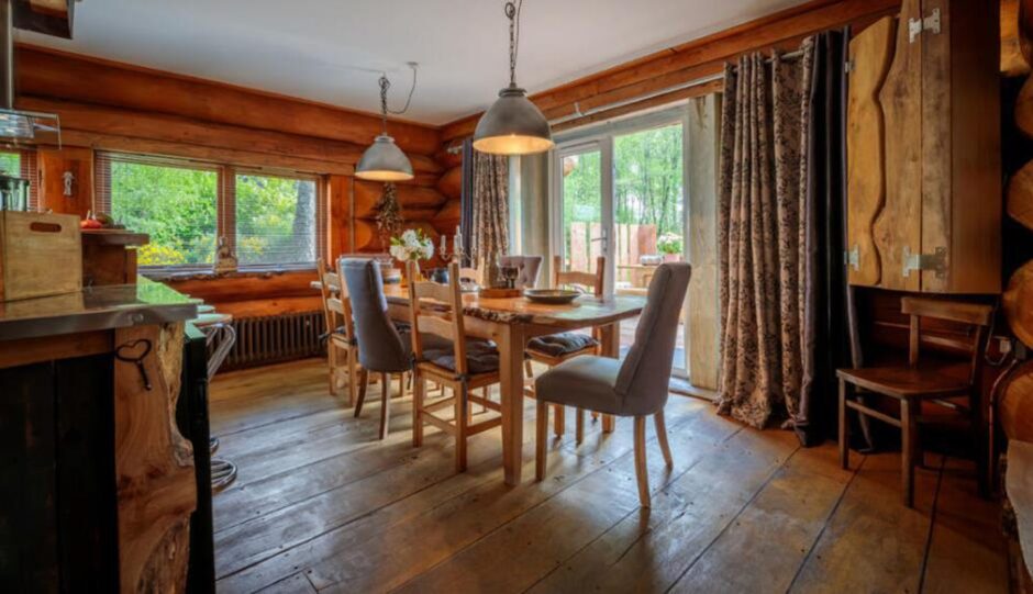 Dining room with large wooden table to complement the home's structure.