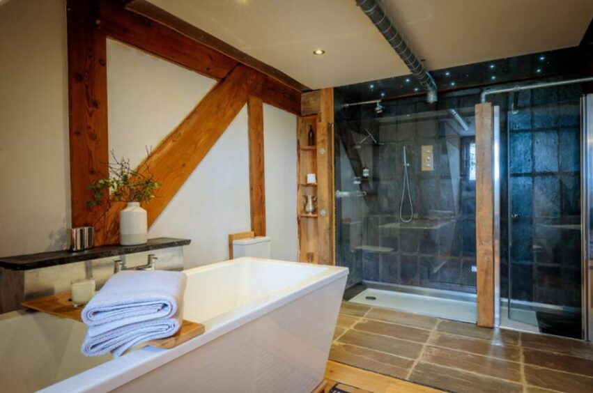 Large white back and black marble walk-in shower.