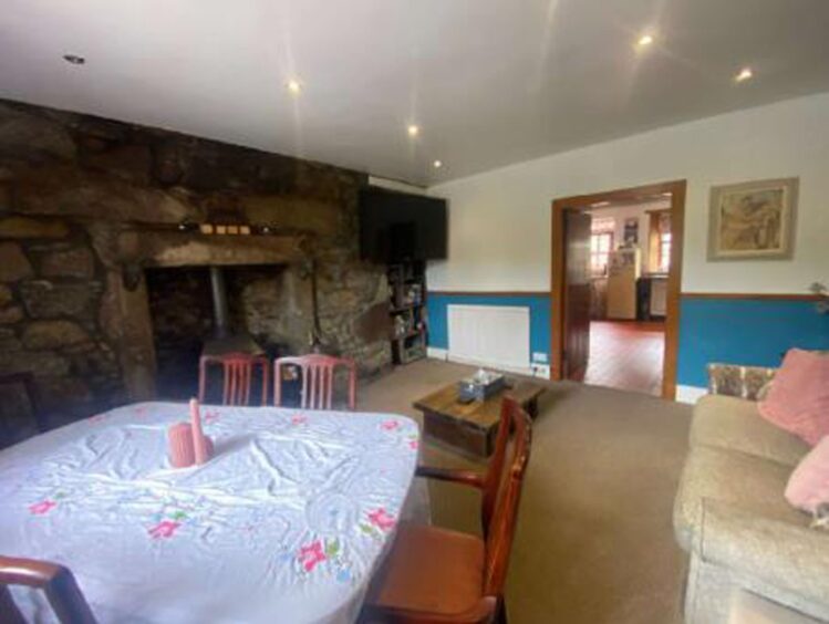 The central focus of the room lies with the exposed stonework on the chimney breast wall, with a log-burning stove creating a warm feel to the family space.