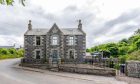 Old Manse in New Aberdour with grey and light brown stonework.