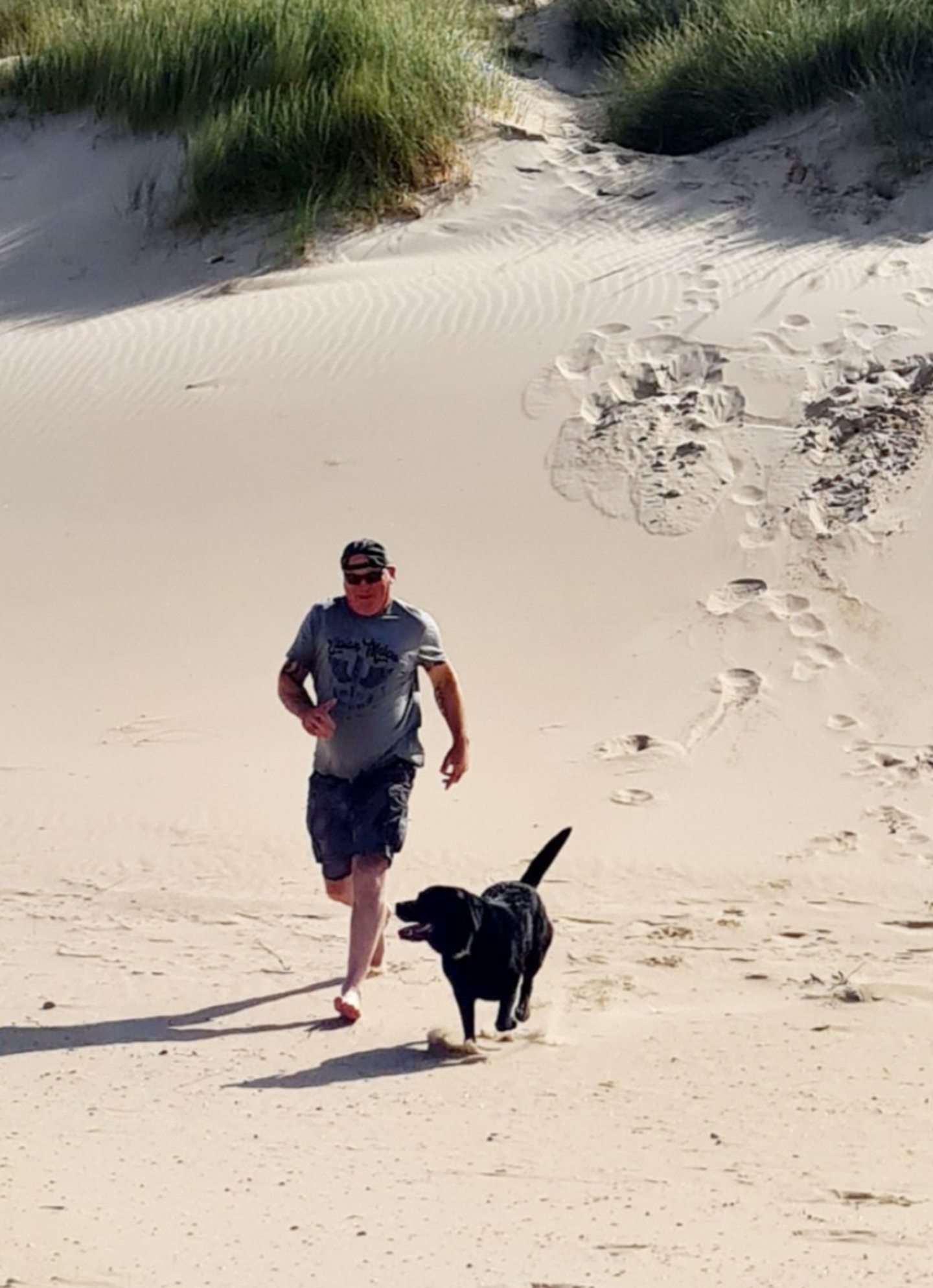 Sadie running down a sand dune with Ian 