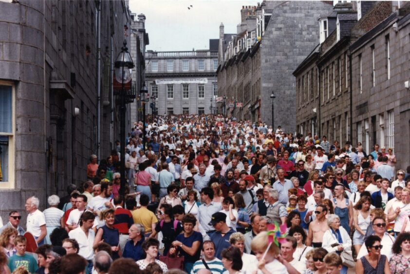 Aberdeen's Marischal Street is a sea of people as sightseers throng towards the harbour and the Tall Ships attractions in 1991. Image: DC Thomson