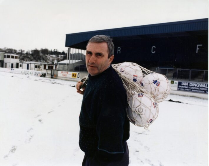 Bobby Wilson holding a net bag of footballs