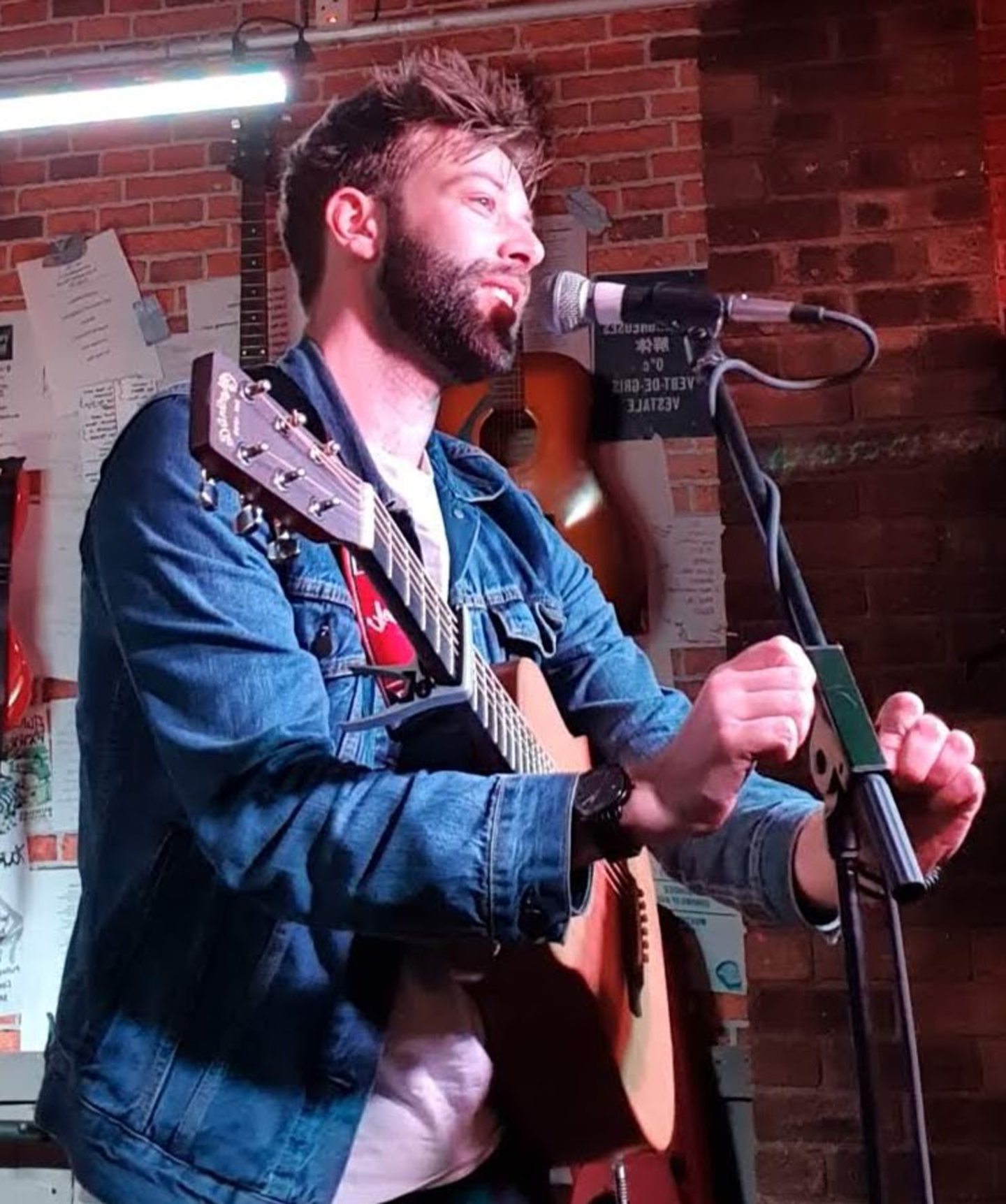 Don Barclay on stage with guitar