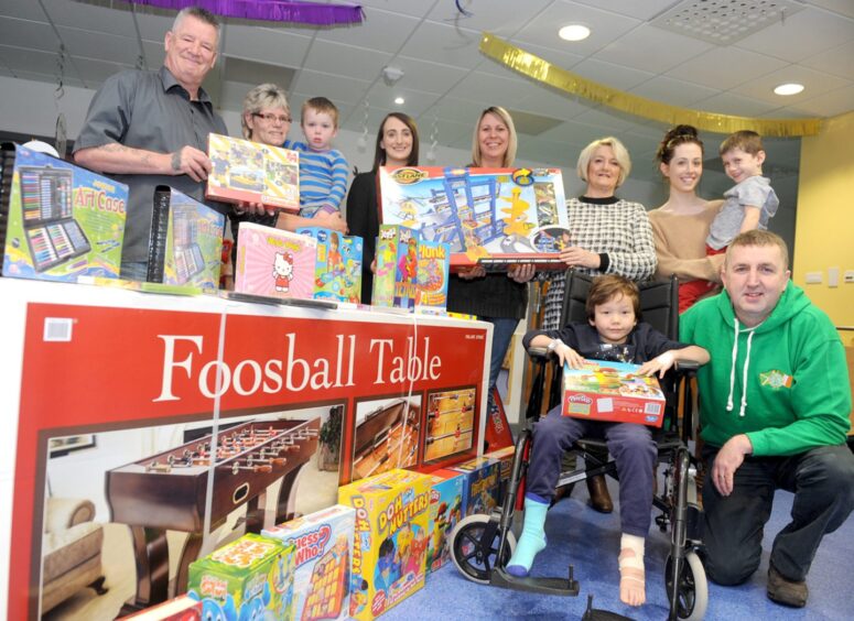 Garry McNulty, in green on the far right, with the Grampian Emerald Celtic Supporters Club making a toy donation to the hospital in 2014. Image: Chris Sumner/DC Thomson