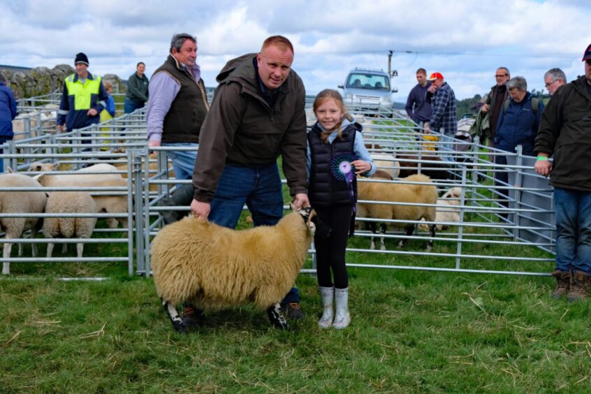 The winner in the Blackface sheep section, with proud owners. 