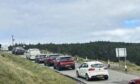 Cars parked at the roadside near the Fairy Pools on Skye