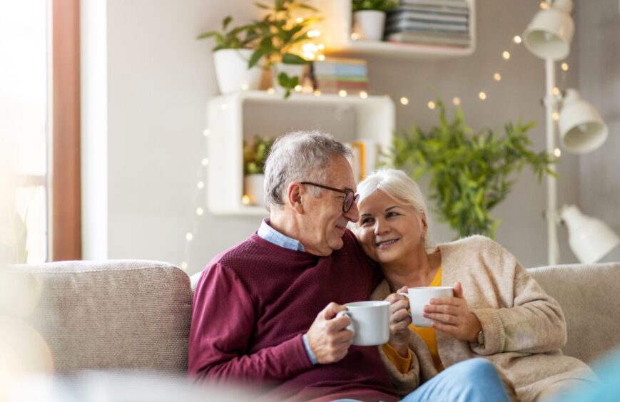 smiling older couple on sofa