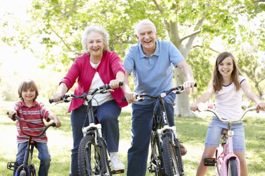 grandparents cycling with grandchildren