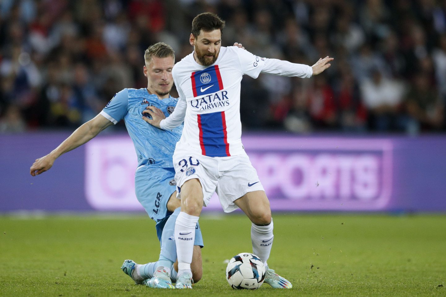 Paris Saint Germain's Lionel Messi (right) and Troyes' Ante Palaversa (left) in action during a French Ligue 1 soccer match between PSG and Troyes, in Paris, in October 2022. Image: Shutterstock.