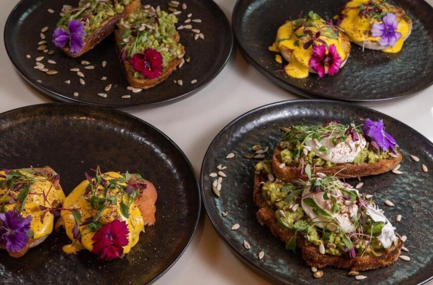 Food from restaurants in Aberdeenshire, featuring 4 black plates with colourful food.